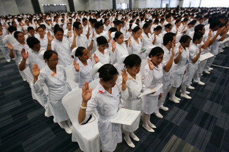 Nursing graduates take their oath in Manila.