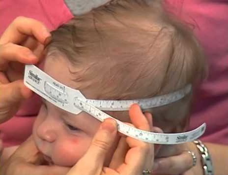 Measuring head circumference using a tape measure. Image via: YouTube.com